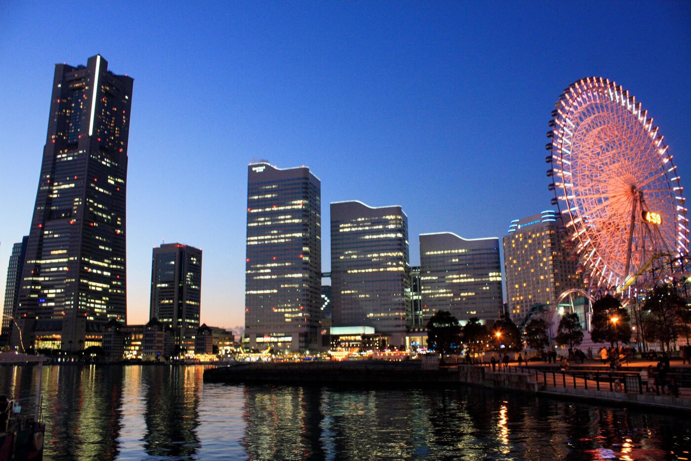 The Minato Mirai skyline reflected in Yokohama harbour at dusk